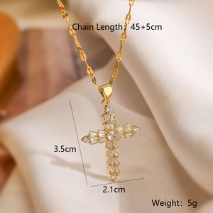 Gold-plated cross pendant necklace with zircon stones on beige silk background