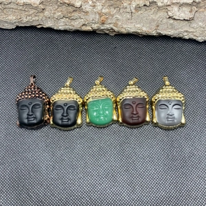 Detailed display of five colorful crystal buddha head pendants with gold metal frames