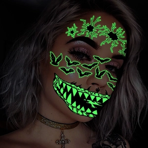 Luminous Halloween face tattoos with glowing green mouth and spider patterns