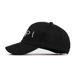 Close-up of high-quality white 3D embroidery on a black cotton baseball cap surface