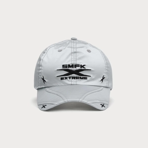 Close-up of silver-gray baseball cap featuring black X embroidery and text details