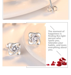 Close-up of S999 sterling silver clover earrings with a round zircon in the center