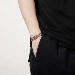 Detail of two-tone stainless steel keel chain bracelet with gold and silver links