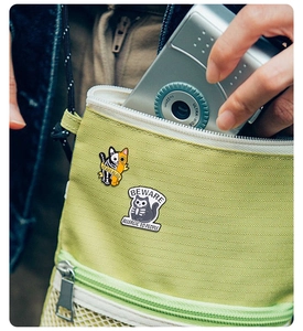 Detail of Halloween cat enamel pins showing Dead & Alive and Beware text on a fabric bag