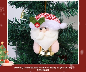 Detail of Christmas Santa bell ornament with red knitted hat and golden bell on tree