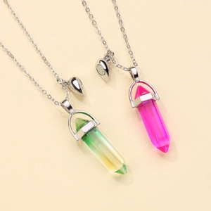 Close-up of hexagonal crystal pendants with heart magnet connector for couple necklaces