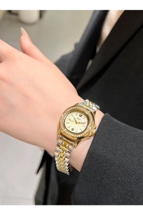 Wrist view of a luxury Gedi women's watch with rhinestone bezel and bicolor metal strap