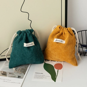 Large corduroy drawstring pouch in dark green and yellow for makeup organization