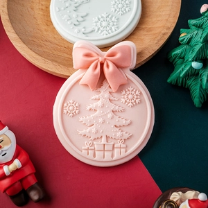 Pink Christmas silicone fondant mold with bow, featuring embossed tree and snowflake patterns