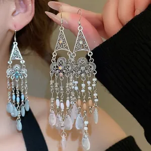 Bohemian silver earrings with triangle crystal patterns and beaded teardrop tassels