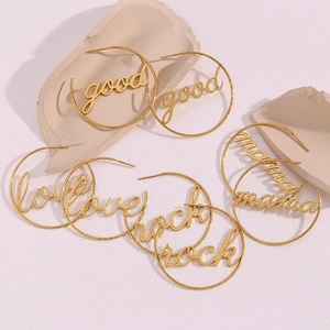 Detail of 18K gold plated hoop earrings featuring hollow good, love, rock and mama words