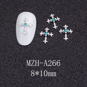 Detailed view of silver Gothic cross nail charms with teal zircon inlay, size 8x10mm
