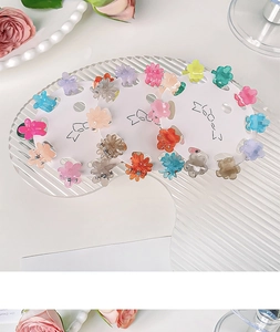 Macro detail of mini flower hair claws in colorful jelly tones on display card