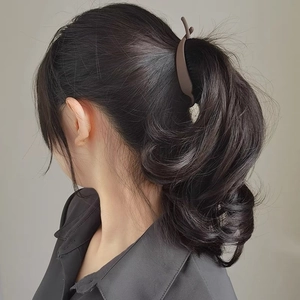 Matte dark brown hair clip for women shown on a ponytail from a side-back view
