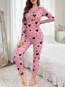 Detail of pink heart-print loungewear set showing ribbed texture and slim-fit long sleeves