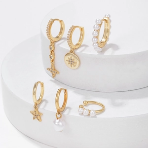 Elegant 6-piece gold earring set featuring pearls, star pendants, and zircon studs