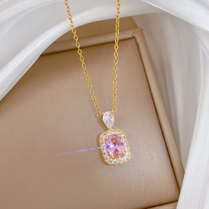 Macro shot of titanium steel necklace with pink oval gemstone and crystal inlay