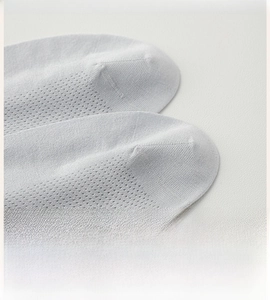 Macro detail of breathable mesh fabric and flat seamless toe on men's cooling cotton socks
