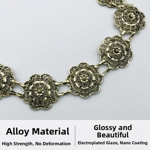 Detail of vintage gold metal waist chain featuring intricate hollow floral mandala links