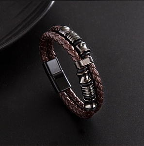 Close-up of double-layer brown braided leather bracelet with black magnetic clasp