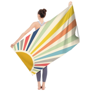 Detail view of microfiber beach towel with vintage sun rays and retro stripe pattern