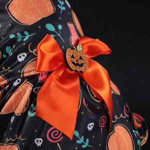 Halloween pumpkin pet dress detail with orange satin bow and sparkling glitter jack-o-lantern
