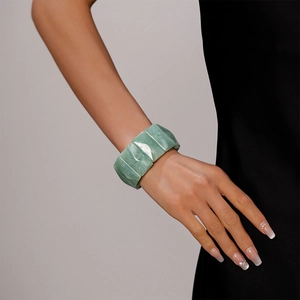 Close-up of green marble texture resin cuff bracelet with geometric chunky design