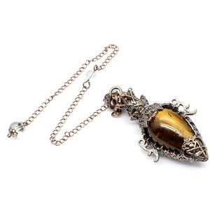 Close-up of tiger's eye stone pendant in a vintage bronze hollow floral metal frame