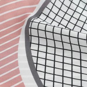 Detail of soft faux silk scarf with pink stripes and black and white checkered patterns
