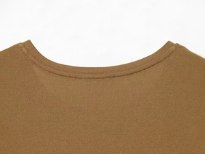 Detail of a brown crew neck knitted shirt showing double-stitched collar craftsmanship