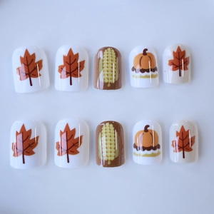 Short square press-on nails with autumn pumpkin and maple leaf patterns for Thanksgiving