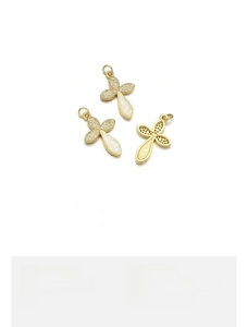 Macro view of 18K gold plated clover cross pendant with blue opal and white zircon