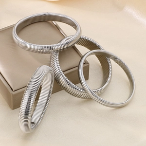 Set of four silver Tubogas stretch bracelets in various widths on champagne silk