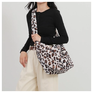 Detail shot of leopard print plush crossbody bag with soft faux fur texture and wide strap