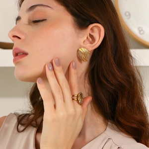 Detailed close-up of 18K gold plated spiral earrings and ring set with pavé cubic zirconia