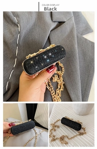 Detailed macro view of a luxury black sequin mini evening bag with elegant gold chain