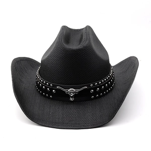 Detailed close-up of a black straw cowboy hat with a bull head emblem and silver studs