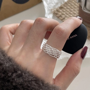 Detail of layered silver ring showing woven metal texture and minimalist design