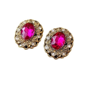 Vintage French style gold earrings with pink gemstones and crystals in macro view