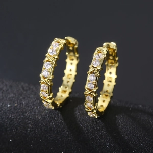 Golden huggie hoop earrings featuring sparkling pave zircons and vintage cross metal lines