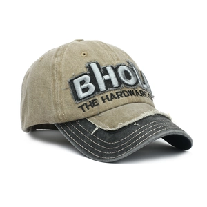 Close-up of 3D embroidered BHO letters on a distressed khaki and black baseball cap