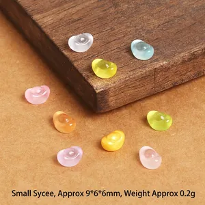 Detailed view of colorful 9x6x6mm mini resin gold ingots for DIY jewelry and crafts