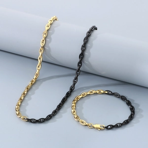 Detail of two-tone gold and black link necklace and bracelet set on display