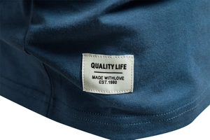 Close-up of a woven hem label on a navy blue cotton V-neck T-shirt for men