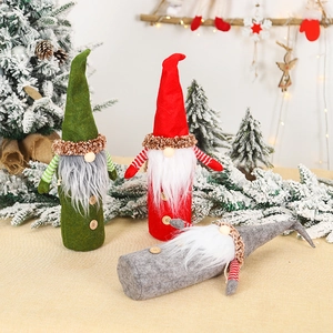 Three Christmas gnome wine bottle covers in red, green, and gray with felt textures
