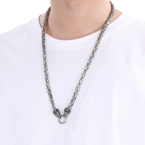 Detailed shot of punk style titanium steel Byzantine chain with double lion head pendants
