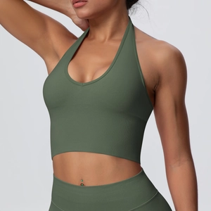 Close-up of seamless dark green halter yoga bra with wide ribbed hem and U-neck detail