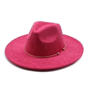 Detail of rose red suede fedora hat featuring a stylish gold metal ring with ball accents