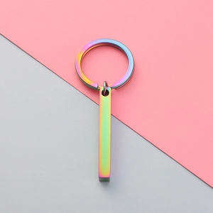 Macro detail of rainbow gradient metallic rectangular prism keychain on a modern background