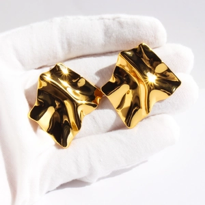 Irregular wavy gold earrings with mirror finish and fluid crumpled metal design